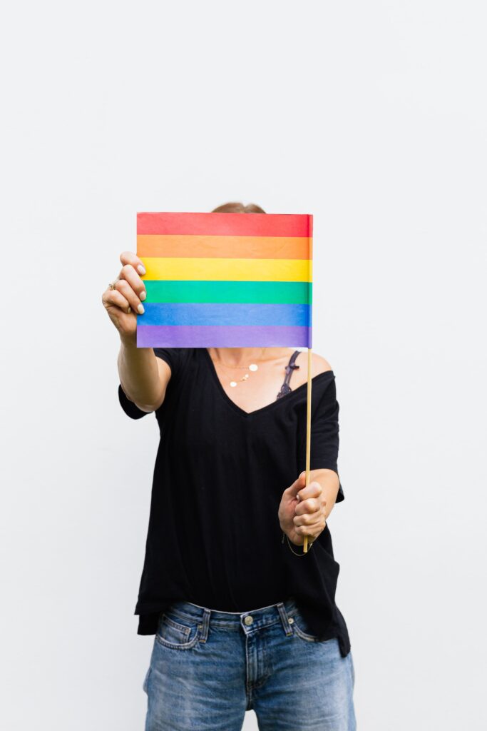 A girl holding a pride flag: Government welfare schemes for transgender